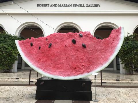 Watermelon sculpture sits on a block in front of the Coral Gables Museum plaza