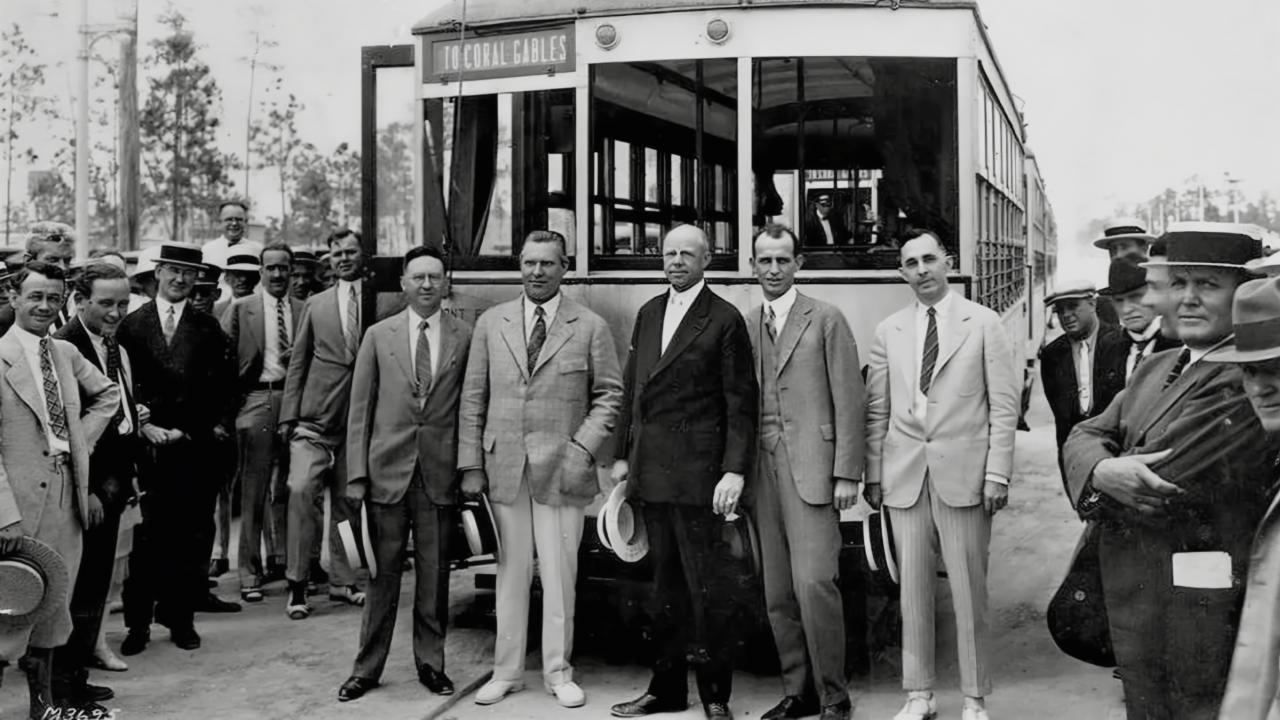 Black and white photo of George Merrick Doc Dammers, Jack baldwin, and Telfair Knight in front of a trolley 1925