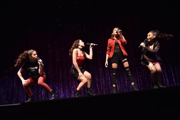 Four young performers singing