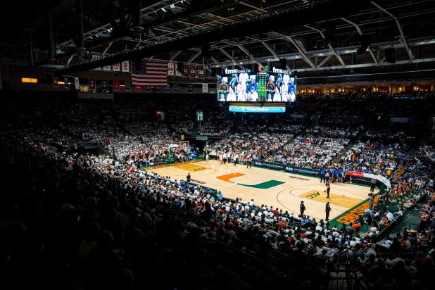 Basketball court lit with crowded stadium