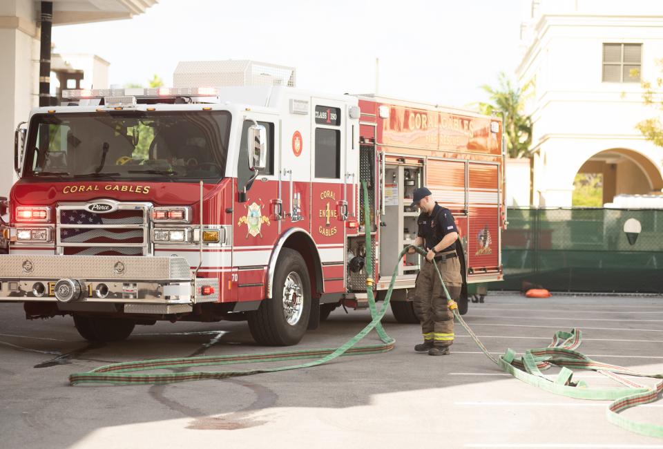 Fire Fighter with Hose and Truck