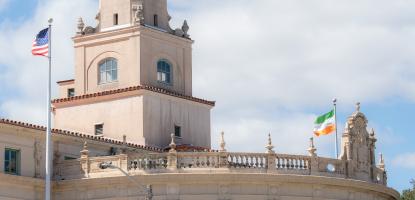 The U.S. and City of Coral Gables flags flying over Coral Gables City Hall