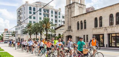 Image of a Gables bike tour in front of the Coral Gables Museum