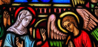 Stained glass depiction of Mary, baby Jesus, and angels