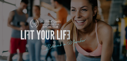 Woman in gym clothes smiling bends down. Behind her a blurred background of people talking at the gym. 