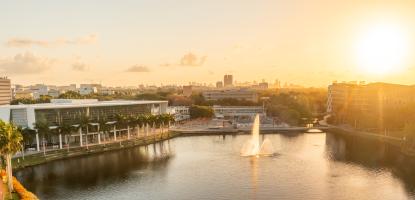 Aerial view of University of Miami campus with lake and buildings during a sunrise