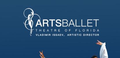 Two ballet dancers posed on one leg in a blue background wearing grey tights and a flowy white shirt