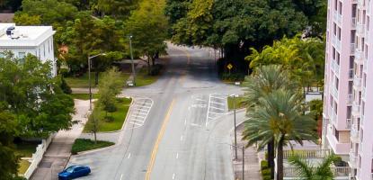 Biltmore Way road, cars parked, with tall pink building on the right
