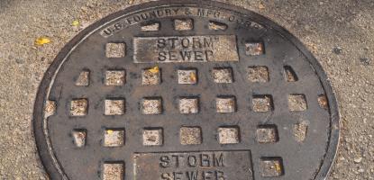 Grayish black sewer cover