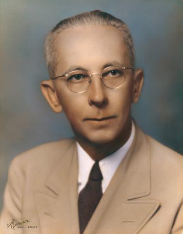 Painted portrait of Paul D. McGarry wearing a light tan suit and glasses