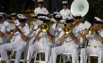 Members of the U.S. Navy Band performing while seated