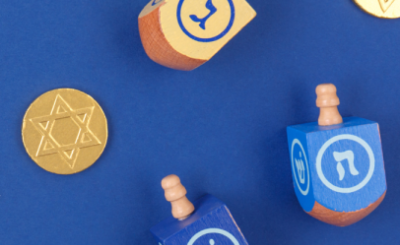 Dreidels in front of a blue background