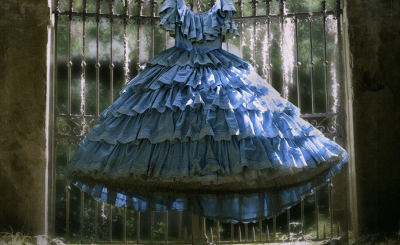 Natchez poster, a blue dress in shallow focus in the distance