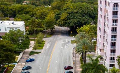 Biltmore Way road, cars parked, with tall pink building on the right