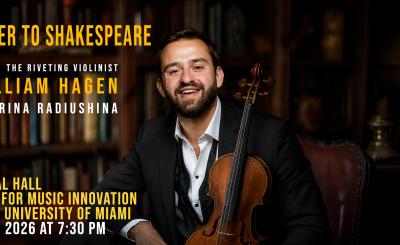 Hagen in suit smiles and holds violin 