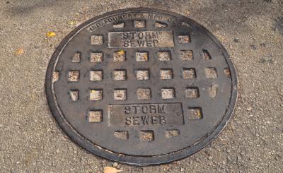 Grayish black sewer cover