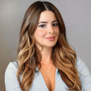 Chelsea Granell in light blue jacket with light gray background