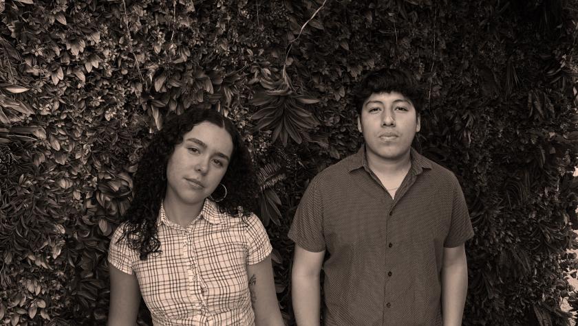 Laura and Josias in nice attire in a black white closer to sephia color photo